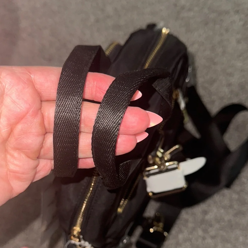 Sleek Black Backpack with Gold Zippers